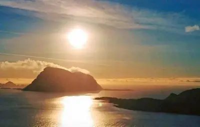 a sun setting over a mountain in the ocean at 4 Bedroom Gorgeous Home In Atløy in Herland