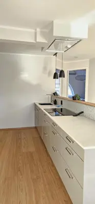 a white kitchen with a sink and a counter at Best view in town in Bergen