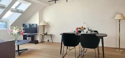 a living room with a table and chairs and a tv at Best view in town in Bergen
