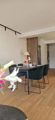a living room with a dining room table and chairs at Best view in town in Bergen