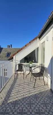 a patio with two chairs and a table on a balcony at Best view in town in Bergen
