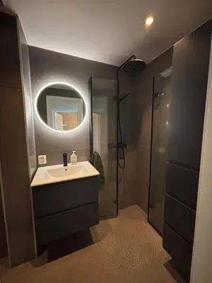 a bathroom with a sink and a mirror at 1-bedroom apartment in Trondheim