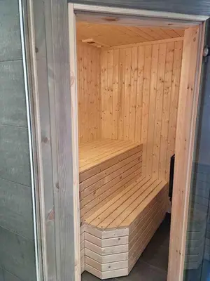 a wooden sauna in a room with wooden walls at Skogbrynet hytte in Svingvoll