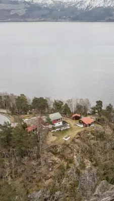 an aerial view of a house next to a body of water at Hardangerfjord panorama 2 in Kvam