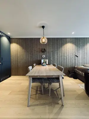 a dining room with a wooden table and chairs at Exclusive and cozy apartment central Geilo area in Geilo