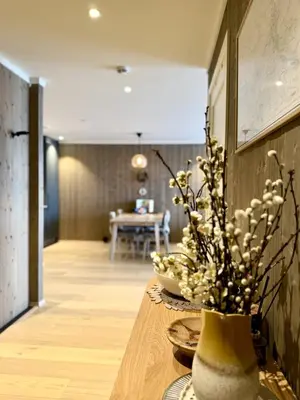 a vase with flowers on a table in a room at Exclusive and cozy apartment central Geilo area in Geilo