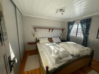 a small bedroom with a bed with white sheets at Charming Mountain Retreat Near Ski Trails And Beitostølen Center in Beitostøl