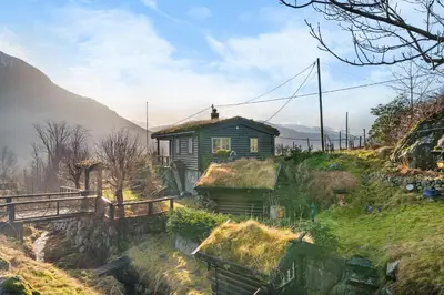 a house with grass on the roof on a hill at Gildeskaal - A Fairytale Stay in Rosendal in Rosendal