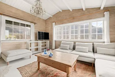 a living room with a couch and a coffee table at Gildeskaal - A Fairytale Stay in Rosendal in Rosendal
