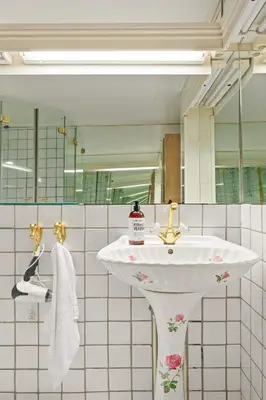 a bathroom with a sink and a mirror at Gildeskaal - A Fairytale Stay in Rosendal in Rosendal