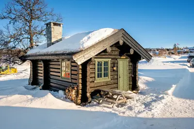 a small log cabin with snow on the roof at Koselig hytte Gålå Vakre Lauvåsen in Sør-Fron