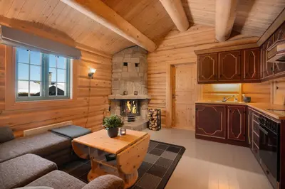 a living room with a couch and a table in a cabin at Koselig hytte Gålå Vakre Lauvåsen in Sør-Fron