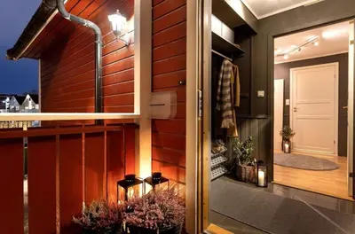 a balcony with a door to a room with plants at Trondheim VM-arena in Trondheim