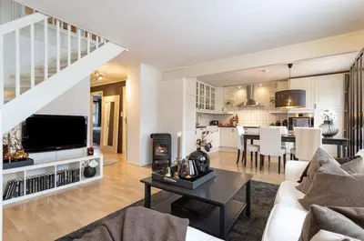a living room with a couch and a table and a kitchen at Trondheim VM-arena in Trondheim