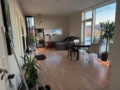 a living room with a table and a couch at Near Granåsen in Trondheim