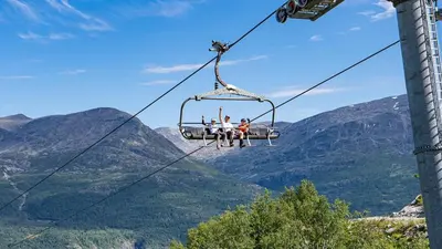 a group of people riding a ski lift in the mountains at New! Apartment Fjellandsbyen Hemsedal Ski&bike in Kyrkjebøen