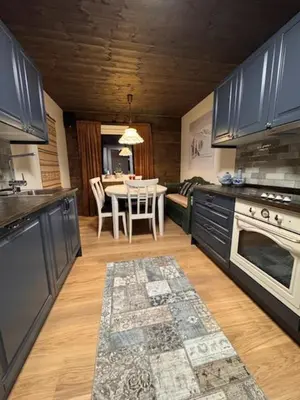 a kitchen with a table and a dining room at Ustedalen Lodge in Geilo