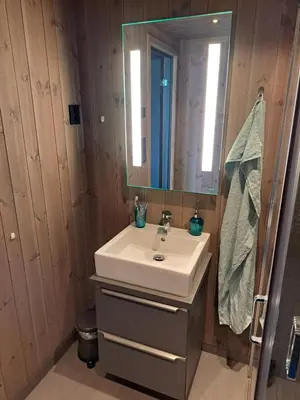 a bathroom with a sink and a mirror at Rabbelia by Norgesbooking - cabin in great hiking and skiing area in Ål
