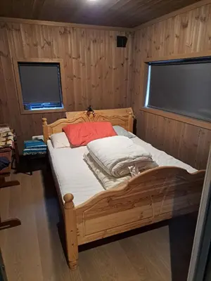 a bedroom with a wooden bed in a room at Rabbelia by Norgesbooking - cabin in great hiking and skiing area in Ål
