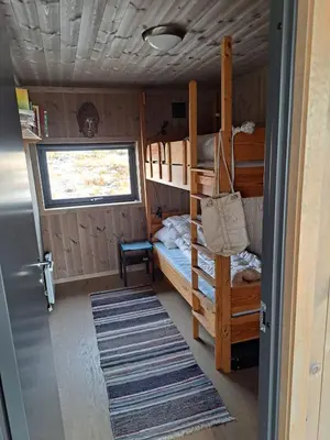 a bedroom with two bunk beds and a door at Rabbelia by Norgesbooking - cabin in great hiking and skiing area in Ål