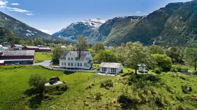 an aerial view of a house in the mountains at Huse Gjestegard in Kinsarvik