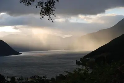 a view of a body of water with mountains in the background at Huse Gjestegard in Kinsarvik