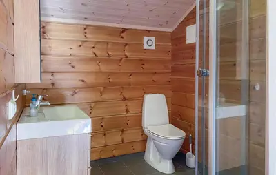 a bathroom with a toilet and a sink and a shower at Cozy Home In Stryn With Sauna in Stryn