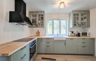 a kitchen with white cabinets and a stove top oven at Amazing Home In Kysnesstrand With Wifi in Oppheim