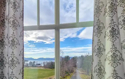a window with a view of a field and mountains at Amazing Home In Kysnesstrand With Wifi in Oppheim