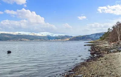 a body of water with snow covered mountains in the background at Amazing Home In Kysnesstrand With Wifi in Oppheim