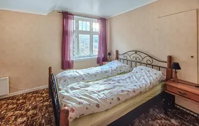 a bedroom with a bed with a wooden frame and a window at Amazing Home In Kysnesstrand With Wifi in Oppheim