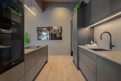 a large kitchen with two sinks and a counter at Penthouse with fjord view and parking in Sogndal