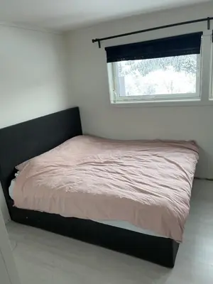 a bed in a bedroom with a window at Trondheim in Trondheim