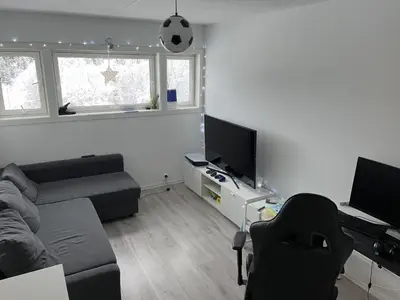a living room with a couch and a tv at Trondheim in Trondheim