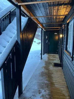 a porch of a house with snow on the ground at Apartment Røldal in Håra