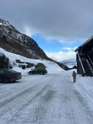 a person walking down a snow covered road at Apartment Røldal in Håra
