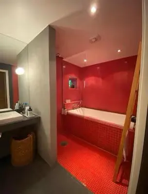a red bathroom with a tub and a sink at Luxury private house with Amazing view! in Trondheim