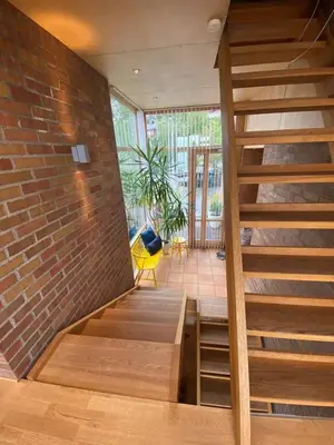 a staircase in a room with a brick wall at Luxury private house with Amazing view! in Trondheim