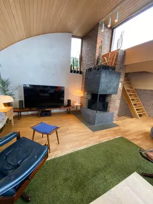 a living room with a television and a fireplace at Luxury private house with Amazing view! in Trondheim