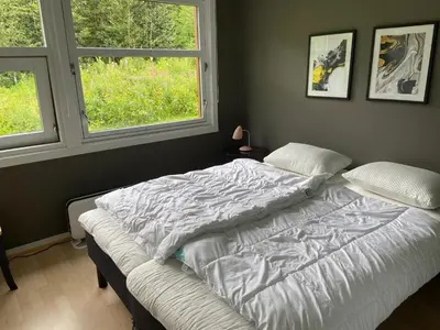 a bed in a bedroom with two windows at Actif 318 apartment - close to ski slopes in Ål in Ål