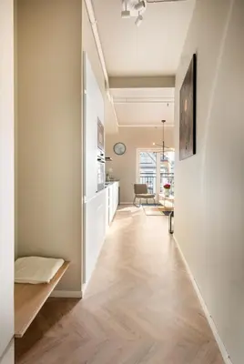 a hallway with white walls and wood floors at 3F - In the heart of Trondheim in Trondheim