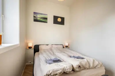 a bedroom with a bed with two pillows on it at 3F - In the heart of Trondheim in Trondheim
