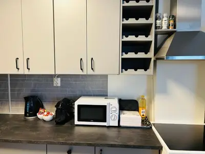 a kitchen with a white microwave on a counter at Bright and nice downtown apartment in Lillehammer