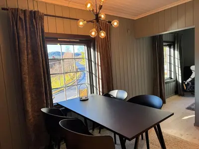 a dining room with a table and chairs and a window at Smart and beautiful micro house - Great base for mountain adventures in Hedalen