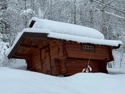 a log cabin with snow on top of it at Smart and beautiful micro house - Great base for mountain adventures in Hedalen