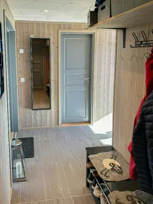 a room with a door and a table and a mirror at Architect Designed Cabin With Panoramic Views in Ål