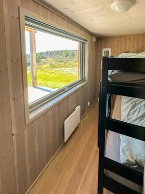 a room with two bunk beds and a window at Architect Designed Cabin With Panoramic Views in Ål