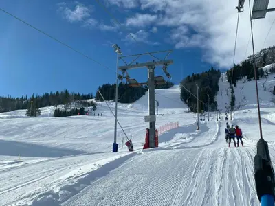 a group of people on a ski lift in the snow at Architect Designed Cabin With Panoramic Views in Ål