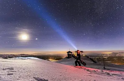 a man holding a snowboard on top of a snow covered mountain at Cabin With Ski Inski Out In Rauland in Rauland