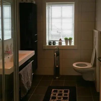a bathroom with a toilet and a sink and a window at Cabin With Ski Inski Out In Rauland in Rauland
